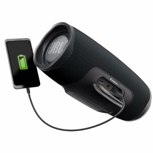 Portable speaker charging a smartphone.